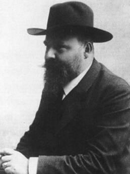 Historisches Schwarz-Weiß-Porträt eines Mannes mit Vollbart und Hut im Profil.